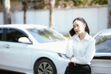 Asian woman calls insurance company for help after car accident