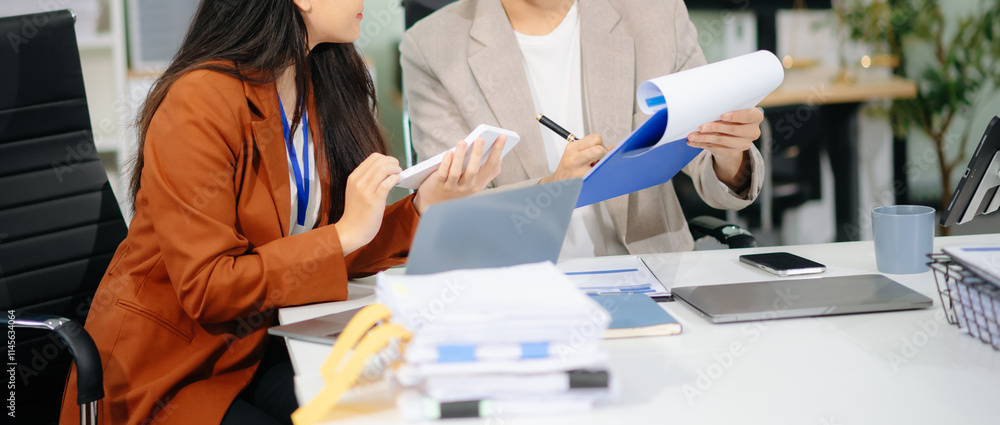 Poster businessman hand using laptop and tablet with social network diagram and two colleagues discussing d