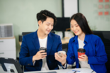 Two business worker standing and holding a coffee cup in modern office, successful, celebration,