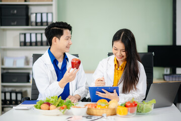 Doctors sharing fresh vegetables, promoting health and nutrition. Ideal for wellness, healthcare,...