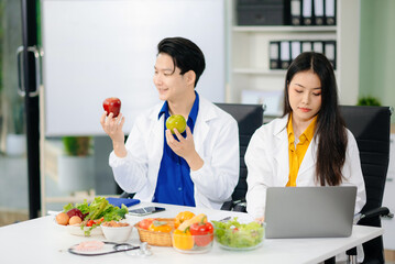 Doctors sharing fresh vegetables, promoting health and nutrition. Ideal for wellness, healthcare,...