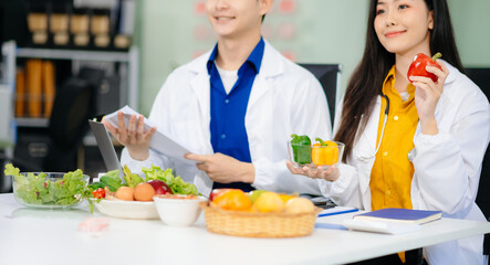 Doctors sharing fresh vegetables, promoting health and nutrition. Ideal for wellness, healthcare,...