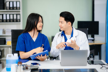 Fototapeta premium Professional healthcare team consultation a doctor and nurse collaborating in a clinic, discussing treatment plans,