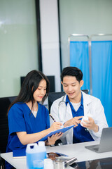 Fototapeta premium Professional healthcare team consultation a doctor and nurse collaborating in a clinic, discussing treatment plans,