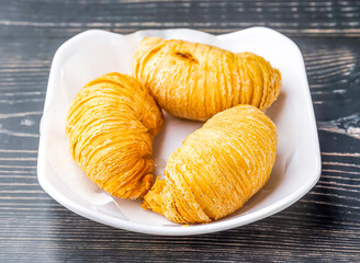 Golden Carrot Puff Pastry served in dish isolated on wooden table side view of hong kong food