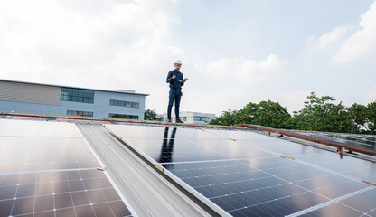 Engineer service check installation solar cell on the roof of factory. Silhouette technician inspection and repair solar cell on the roof of factory. Technology solar energy renewable.