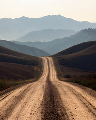 Dirt Road Leading to Hazy Mountain Range