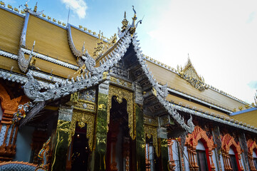 Fototapeta premium Buddha statue and Church, Lanna Architecture at Watsridonmoon, smbols of Buddhism, South East Asia at Chiangmai Northern Thailand