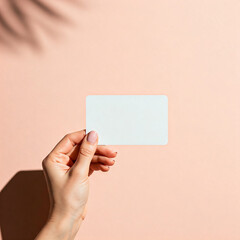 Women hand hold blank card id on light pink background, Featuring Subtle Textures, and Soft Shadows Against, copy space