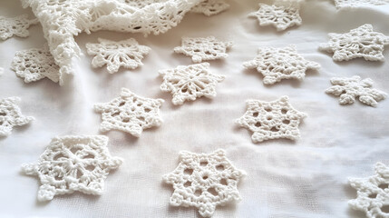 Delicate crocheted snowflakes scattered on white fabric.  Perfect for winter, holiday, or crafting projects.  Handcrafted details create a cozy, elegant feel.