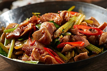 Spicy pork ears with garlic sprouts