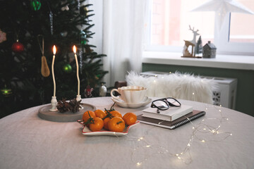 A winter table setting with bright oranges, creating a cozy atmosphere and delightful holiday decorations