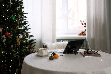 A Cozy Home Office Set Up with tablet, keyboard ,Holiday Decor and a Warm Drink to Enhance the Ambiance