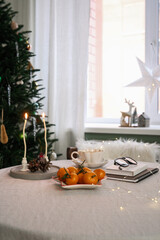 A winter table setting with bright oranges, creating a cozy atmosphere and delightful holiday decorations