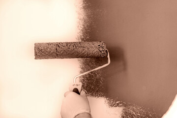 paint roller painting wall pantone 2025 mocha mousse colour. home renovation. 