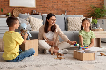 Mother and her children putting toys in wicker basket at home