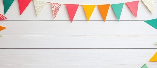 Colorful cut paper flags for Brazilian June party mockup on a rustic white wooden background ideal for festive event promotions and decorations.