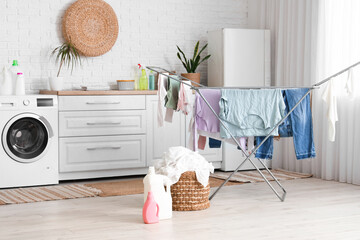 Modern laundry room interior with washing machine, dryer and wicker basket