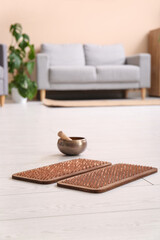 Sadhu board with Tibetan singing bowl on floor in living room