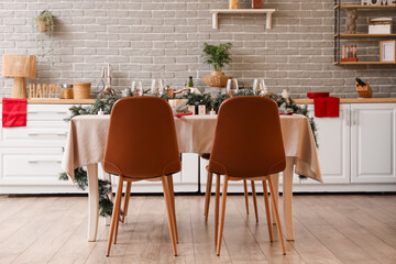 Beautiful table setting with Christmas decorations and fir branches at home