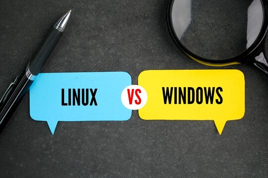 pen, magnifying glass and conversation column paper with the words linux vs windows