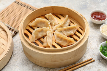 Bamboo steamer with tasty Japanese gyoza on white background