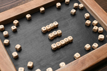 Chalkboard with text KNOW THE RULES and cubes on wooden background