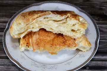 Pate stuffed with natural white cheese spread between layers, Pate is baked buttery, flaky dough that is layered with butter, rolled and folded several times in succession, salty pate