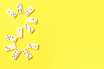 White dominos blocks on yellow background