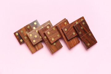 Wooden dominos blocks on pink background