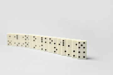 Many white dominos blocks on grey background