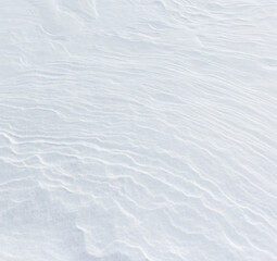 The image is a close up of a snowy beach with a white sand surface