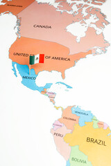 Obraz premium A map of Mexico with the national flag of Mexico on it. The flag is a Vertically striped green-white-red national flag with a central coat of arms