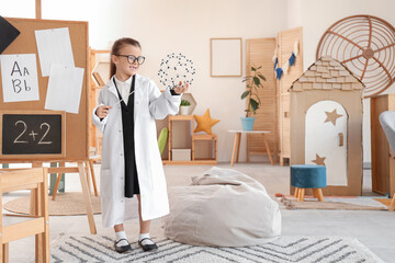 Cute little chemist with pointer and molecular model at home