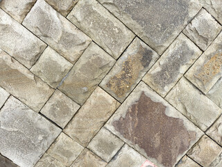 A stone wall with a pattern of squares and triangles