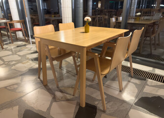 A wooden table with four chairs around it