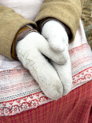 A pair of gloves with a white design on them are being held by a person