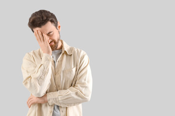 Portrait of worried man on light background