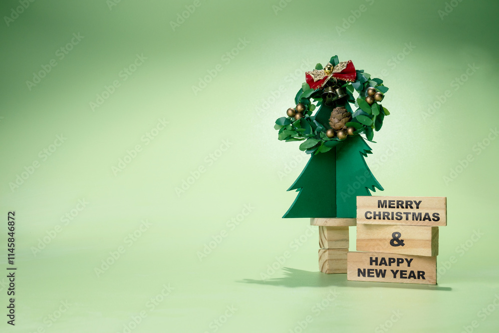 Poster christmas tree miniature with christmas wreath and stack of wooden blocks with text of merry christm