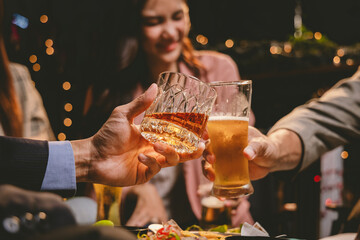A cheerful group of friends enjoying wine and food on a sunny patio. Toasting with wineglasses, they celebrate togetherness in a scenic outdoor setting, blending fun, friendship, and a festive mood.