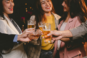 A cheerful group of friends enjoying wine and food on a sunny patio. Toasting with wineglasses, they celebrate togetherness in a scenic outdoor setting, blending fun, friendship, and a festive mood.