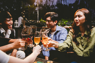 A cheerful group of friends enjoying wine and food on a sunny patio. Toasting with wineglasses, they celebrate togetherness in a scenic outdoor setting, blending fun, friendship, and a festive mood.