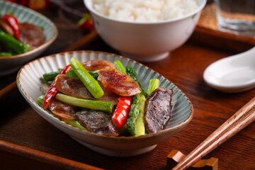 Delicious spicy homemade stir-fried Chinese smoked sausage with asparagus.