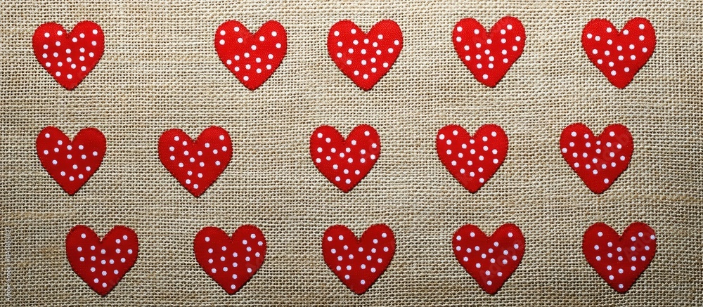 Poster red polka dot hearts on burlap fabric creating a charming background with space for customization an
