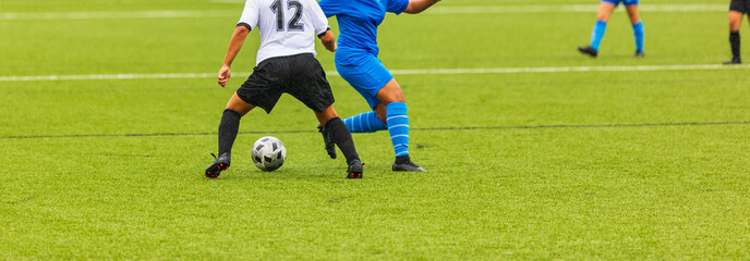 Female Soccer players performs an action play on a professional soccer stadium. Girls playing soccer
