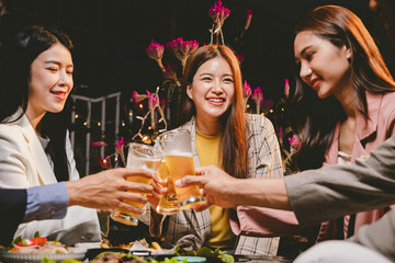 A lively group of friends enjoying beers at a festive pub, toasting with frosty pints. The scene captures the joy of friendship, culture, and celebration over drinks and appetizers on a sunny terrace.