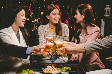 A lively group of friends enjoying beers at a festive pub, toasting with frosty pints. The scene captures the joy of friendship, culture, and celebration over drinks and appetizers on a sunny terrace.