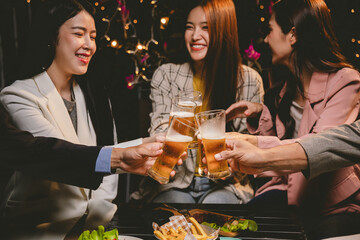A lively group of friends enjoying beers at a festive pub, toasting with frosty pints. The scene captures the joy of friendship, culture, and celebration over drinks and appetizers on a sunny terrace.
