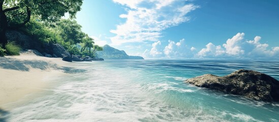 Fototapeta premium Tranquil tropical beach with clear water and lush greenery under a bright blue sky showcasing serene ocean landscape.