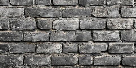 Naklejka premium Textured old grey brick wall background showcasing the rustic charm and character of an aged grey brick wall, perfect for adding an authentic touch to various design projects.